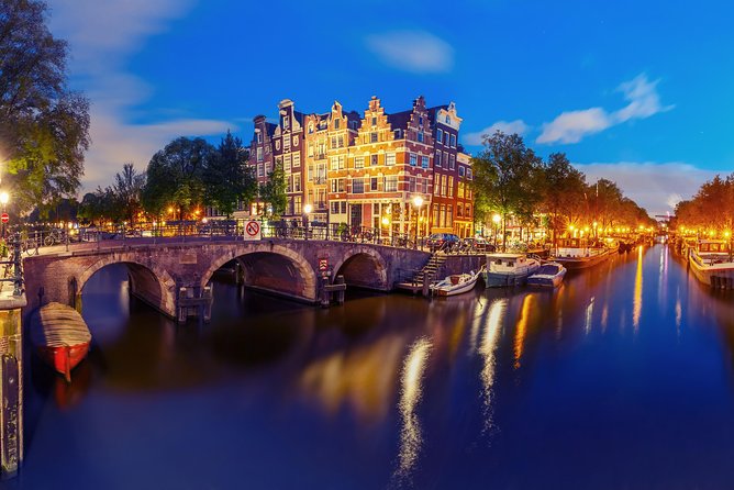 Amsterdam Evening Canal Cruise With Live Guide and Onboard Bar - Exploring Amsterdams Illuminated Canals